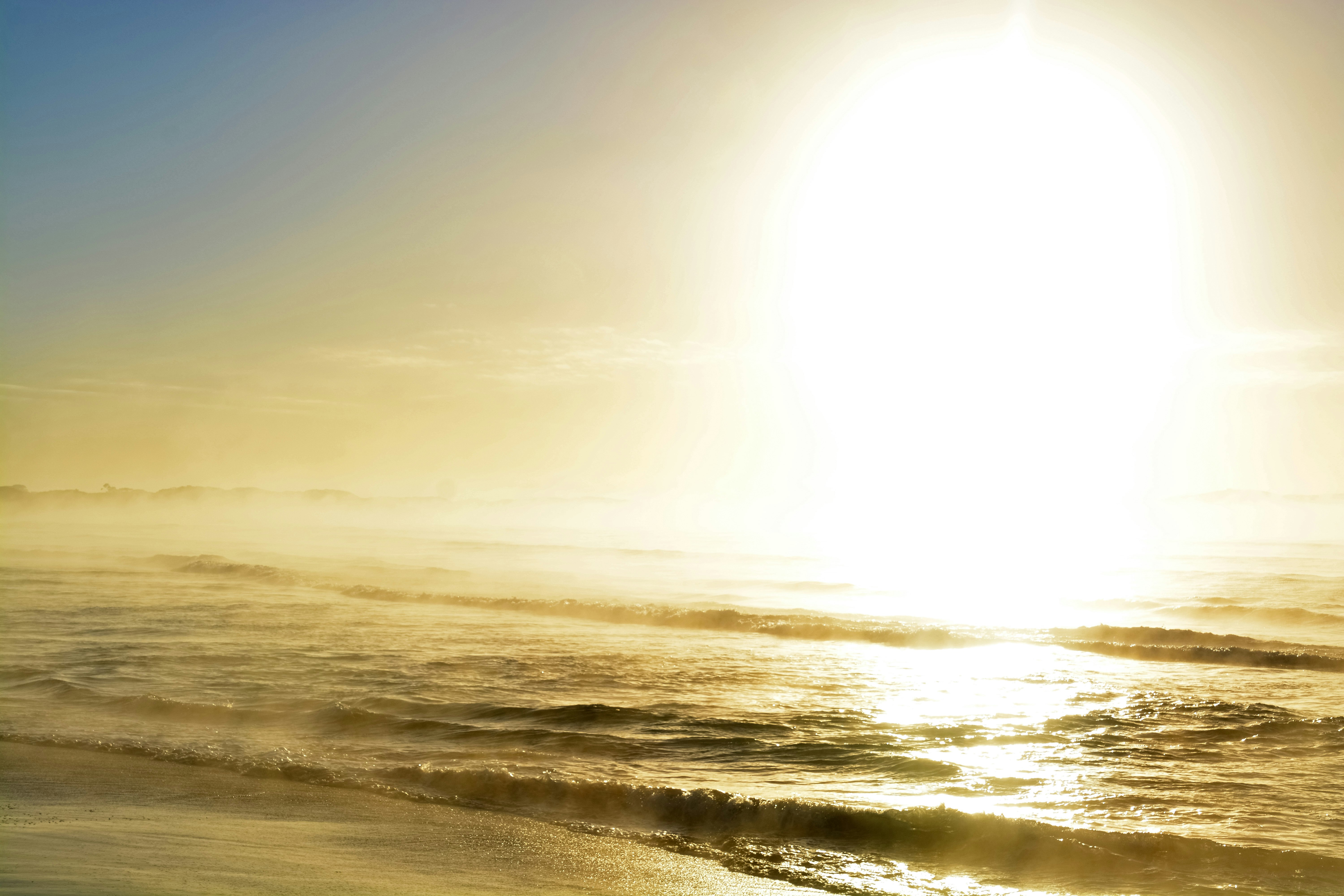 ocean waves crashing on shore during daytime